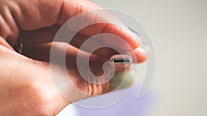 A hand holding usb plug c type close up minimalist technology