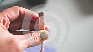 A hand holding usb plug c type close up minimalist technology