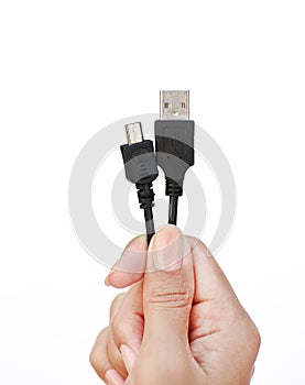 Hand holding usb to micro usb cable on white background
