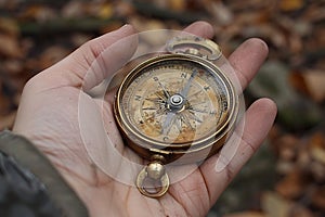 Hand holding a vintage compass