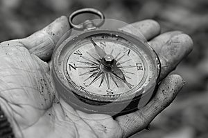 Hand holding a vintage compass