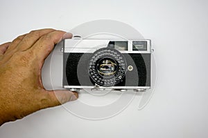Hand holding vintage rangefinder camera isolated on white