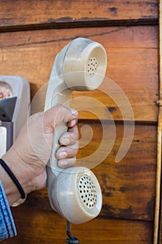 Hand holding vintage telephone receiver,Thailand