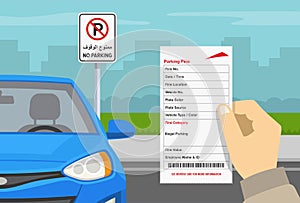 Hand holding violation ticket. Blue car parked in a restricted parking zone. Dubai no parking road sign.