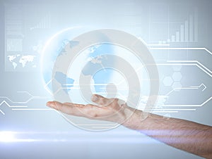 Hand holding virtual sphere globe