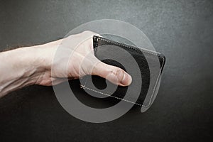 Hand holding a wallet.