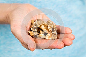 Hand holding walnuts