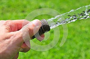 Hand holding a water hose