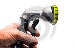 Hand holding a water hose sprinkler with adjustable shower spray