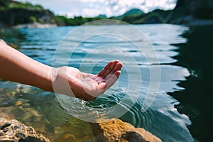 hand holding water in pond