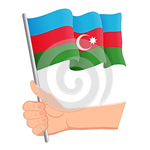 Hand holding and waving the national flag of Azerbaijan. Fans, independence day, patriotic concept. Vector illustration photo