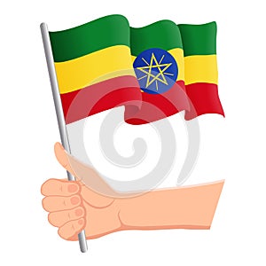 Hand holding and waving the national flag of Ethiopia. Fans, independence day, patriotic concept. Vector illustration