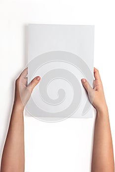 Hand holding white blank paper sheet mockup, isolated. Arm hold clear brochure template mock up.