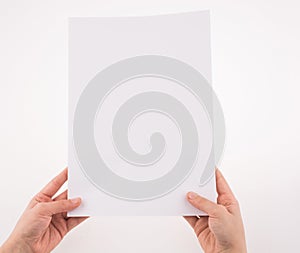 Hand holding a white blank sheet of paper