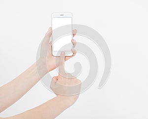 Hand holding white cellphone isolated on white clipping path inside. Online shopping. Top view. Mock up. Copy space. Template.Blan