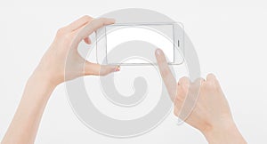 Hand holding white cellphone isolated on white clipping path inside. Online shopping. Top view. Mock up. Copy space. Template.Blan