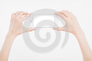 Hand holding white cellphone isolated on white clipping path inside. Online shopping. Top view. Mock up. Copy space. Template.Blan