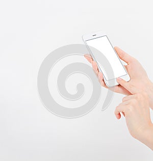 Hand holding white cellphone isolated on white clipping path inside. Online shopping. Top view. Mock up. Copy space. Template.Blan