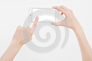 Hand holding white cellphone isolated on white clipping path inside. Online shopping. Top view. Mock up. Copy space. Template.Blan