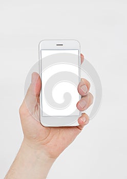 Hand holding white cellphone isolated on white clipping path inside. Online shopping. Top view. Mock up. Copy space. Template.Blan