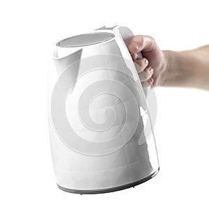Hand holding a white electric kettle. Close up. Isolated on a white background
