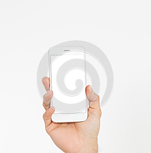 Hand holding white phone on white clipping path inside. Top view.Mock up.Copy space.Template.Blank.