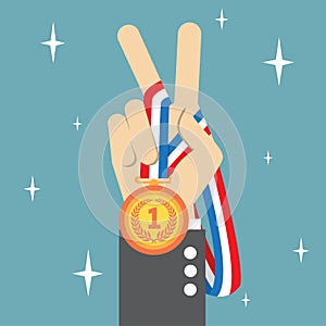 Hand holding a winners medal