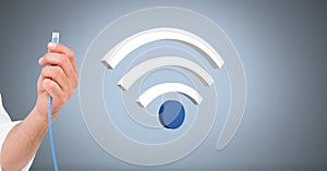 Hand holding wire connection with wi-fi icon