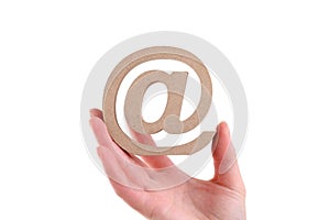 Hand holding wooden email symbol