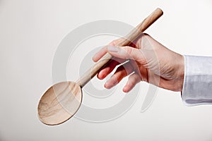 Hand holding wooden spoon