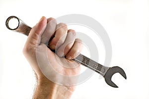 Hand holding wrench isolated.