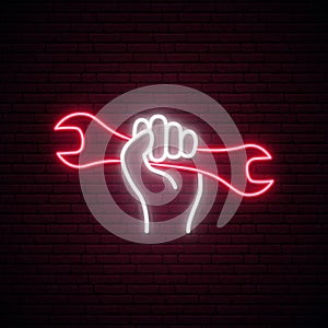 Hand holding wrench neon sign.