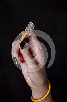 Hand holding yellow Cable Network RJ45 Lan Internet