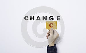 Hand holding yellow card with C alphabet for convert change to chance wording on white background for positive mindset thinking