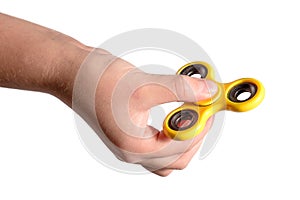 Hand holding yellow fidget spinner photo