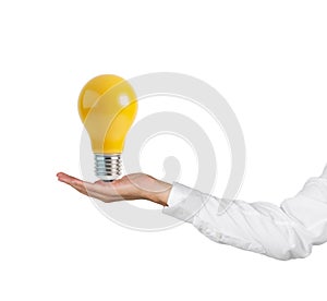 Hand holding yellow lightbulb
