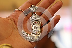 Hand holding the Yemeni Janabiya medal