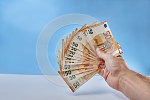 Hand holds 50 euro banknotes in a fan