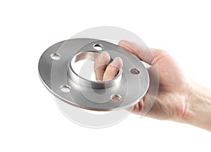 The hand holds the aluminum spacers of the wheels. Isolated on a white background