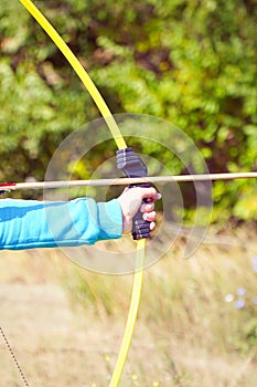 Hand holds archery and arrow