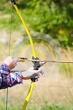 Hand holds archery and arrow