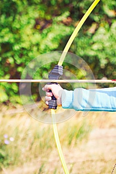 Hand holds archery and arrow