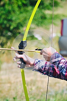 Hand holds archery and arrow