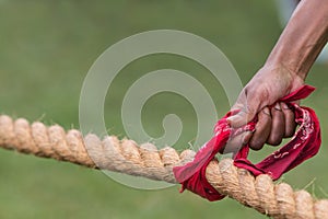 Hand Holds Bandana On Rope Before Tug Of War Contest