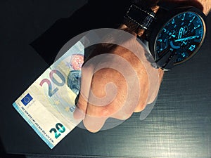 Hand holds a bank note, keep money, money in the palm of your hand, receive money, give money, watch on hand, Europea