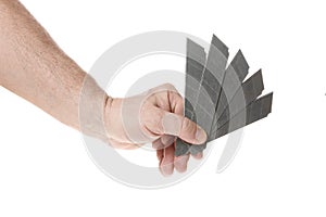 Hand holds a blade for a construction knife on a white background