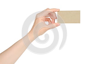 Hand holds blank business card on white background