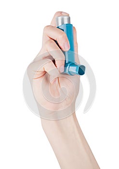 Hand holds blue asthma inhaler for relief asthma