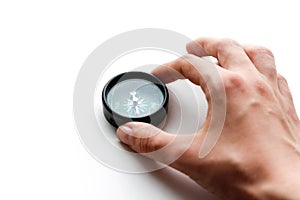 The hand holds a compass. Closeup. Isolated on a white background
