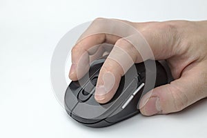 Hand holds a computer mouse.